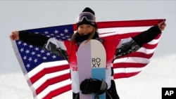United States' Chloe Kim celebrates during the venue ceremony for the women's halfpipe at the 2022 Winter Olympics, Feb. 10, 2022, in Zhangjiakou, China.