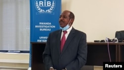 FILE - Paul Rusesabagina, the man who was hailed a hero in a Hollywood movie about Rwanda's 1994 genocide is paraded in handcuffs in front of media at the headquarters of Rwanda's Investigation Bureau, in Kigali, Aug. 31, 2020.