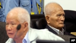 In this photo released by the Extraordinary Chambers in the Courts of Cambodia, Khieu Samphan, left, former Khmer Rouge head of state, and Nuon Chea, right, who was the Khmer Rouge's chief ideologist and No. 2 leader, sit in the court hall before they made closing statements at the U.N.-backed war crimes tribunal in Phnom Penh, file photo.