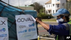 FILE - A worker handles a shipment of COVID-19 vaccines, donated through the U.N.-backed COVAX program, in Madagascar, May 8, 2021. 