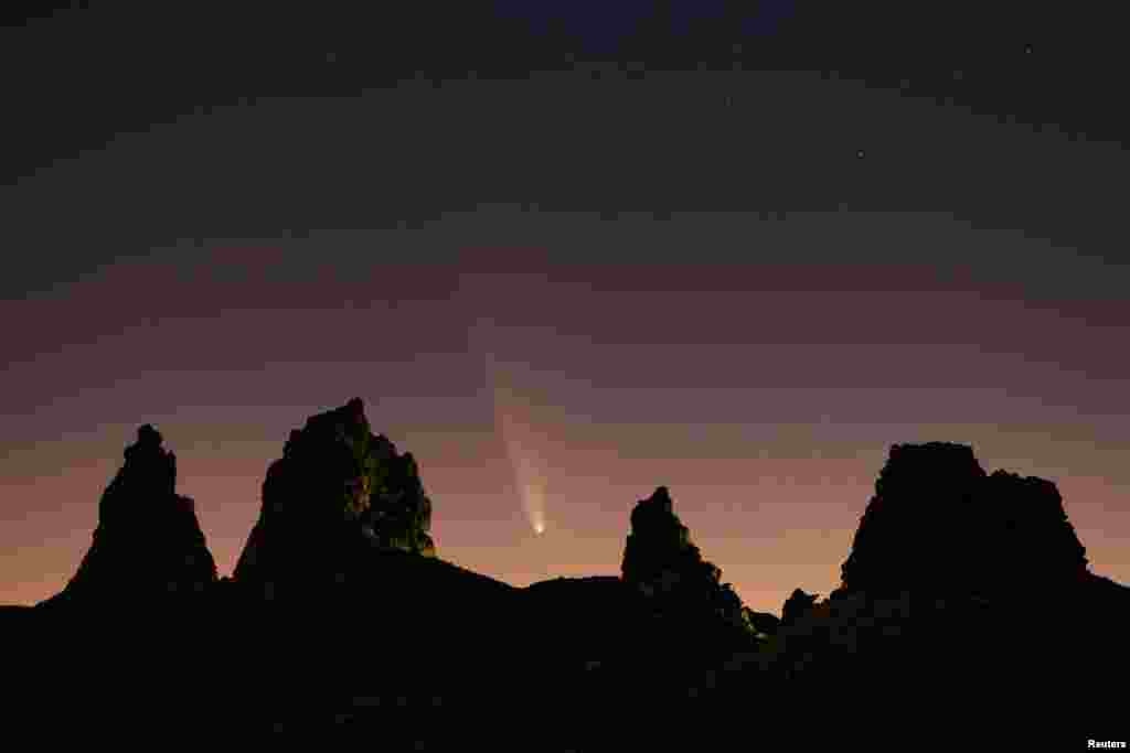 Comet Tsuchinshan-ATLAS, C/2023, with an 80,000 year orbit, passes behind geological formations, tufa spires at Trona Pinnacles, California, Oct. 12, 2024.