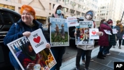 Penzionisana radnica Agencije Sjedinjenih Američkih Država za međunarodni razvoj Julie Hanson Swanson, lijevo, pridružuje se pristalicama radnika USAID-a ispred Ureda USAID-ovog Biroa za humanitarna pitanja u Washingtonu, 21. februara 2025.