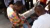 A government official tests an electronic questionnaire in Old Fadama, Accra’s largest slum, ahead of Ghana’s first digital population and housing census in 2020, May 24, 2019.