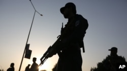 Afghan security forces stand guard after an attack on the American University of Afghanistan in Kabul, Afghanistan, Thursday, Aug. 25, 2016.