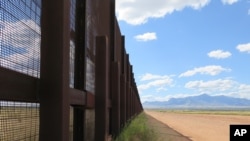 FILE - This Sept. 16, 2015, photo shows a part of a border fence near Naco, Ariz. President Donald Trump wants to build a 10-meter-tall wall along the whole U.S.-Mexico border to deter illegal immigration and smuggling.