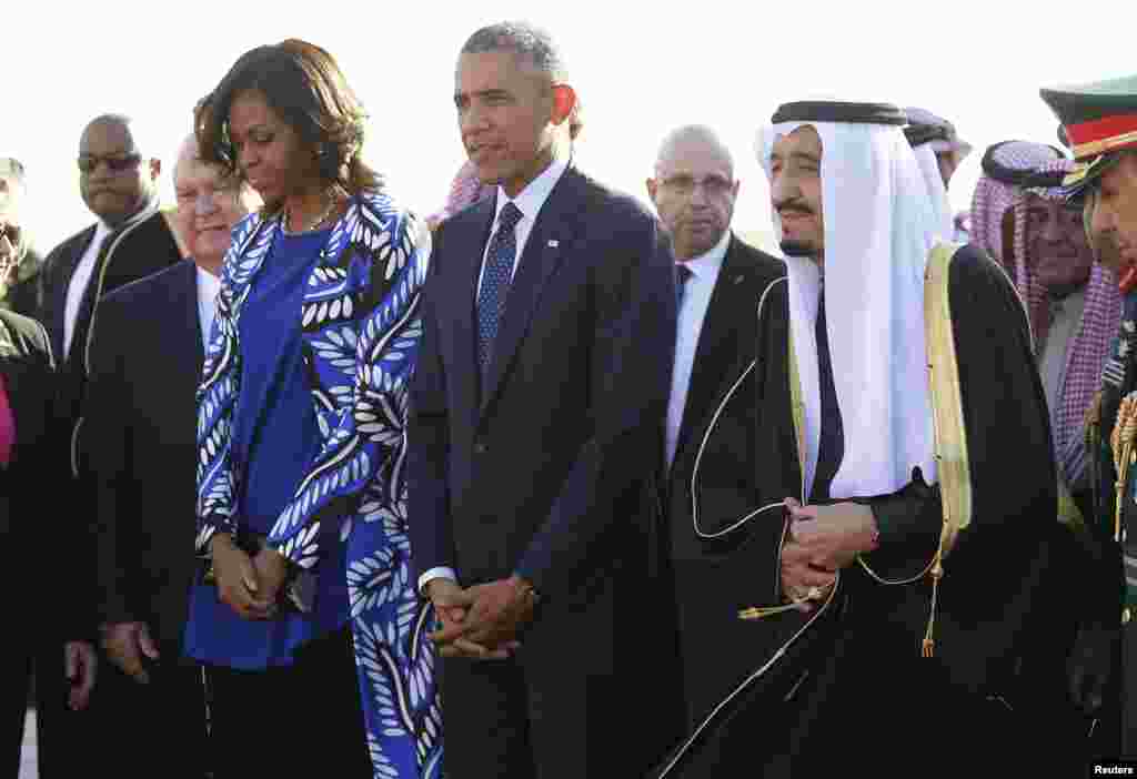 U.S. President Barack Obama and first lady Michelle Obama are greeted by Saudi Arabia's King Salman (R) as they arrive at King Khalid International Airport in Riyadh, Jan. 27, 2015.
