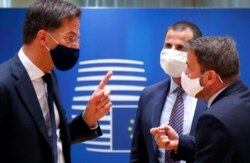 Dutch Prime Minister Mark Rutte, left, speaks with Luxembourg's Prime Minister Xavier Bettel, right, and Malta's Prime Minister Robert Abela, second right, during a round table meeting at an EU summit in Brussels, July 18, 2020.