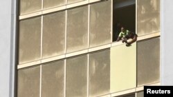 Para pekerja memperbaiki jendela yang rusak di Mandalay Bay Resort, kamar yang digunakan oleh Stephen Paddock untuk melakukan penembakan massal sepanjang Las Vegas Strip, Nevada, 6 Oktober 6, 2017.