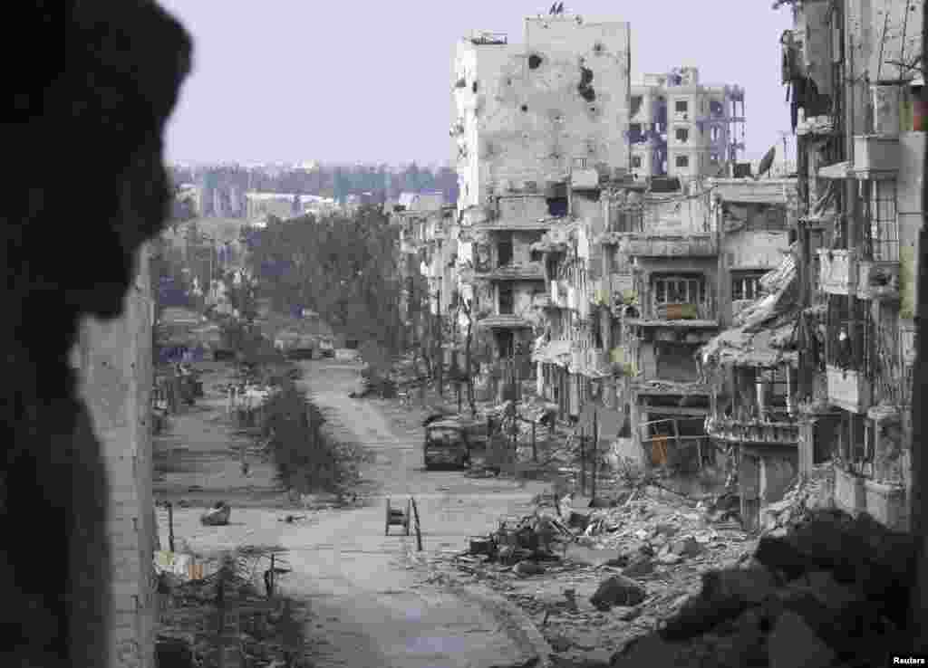 Damaged buildings line a deserted street in the besieged area of Homs, Jan. 9, 2014. 