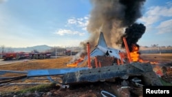 Firefighters douse flames from a plane that went off the runway at Muan International Airport in Muan, South Jeolla Province, South Korea, Dec. 29, 2024. 