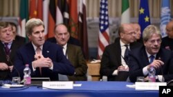 U.S. Secretary of State John Kerry, front left, and Italy's Foreign Minister Paolo Gentiloni, front right, take part in an international conference on Libya at the Ministry of Foreign Affairs in Rome, Dec. 13, 2015.