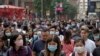 People wear masks on a street in Hong Kong, Jan. 24, 2020.