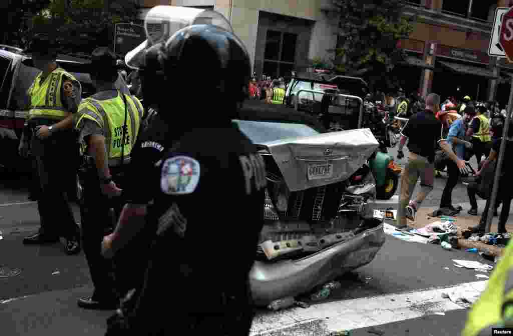 First responders stand by a car that drove through a group of counter protesters at the "Unite the Right" rally Charlottesville, Aug. 12, 2017.