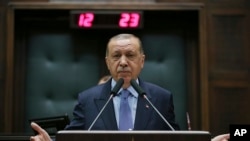 Turkey's President Recep Tayyip Erdogan gesture as he delivers a speech to members of his ruling Justice and Development (AKP) Party, during its weekly meeting in Ankara, Turkey, May 8, 2018.