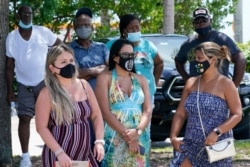 A group waits to get a COVID-19 test, July 31, 2021, in North Miami, Fla.