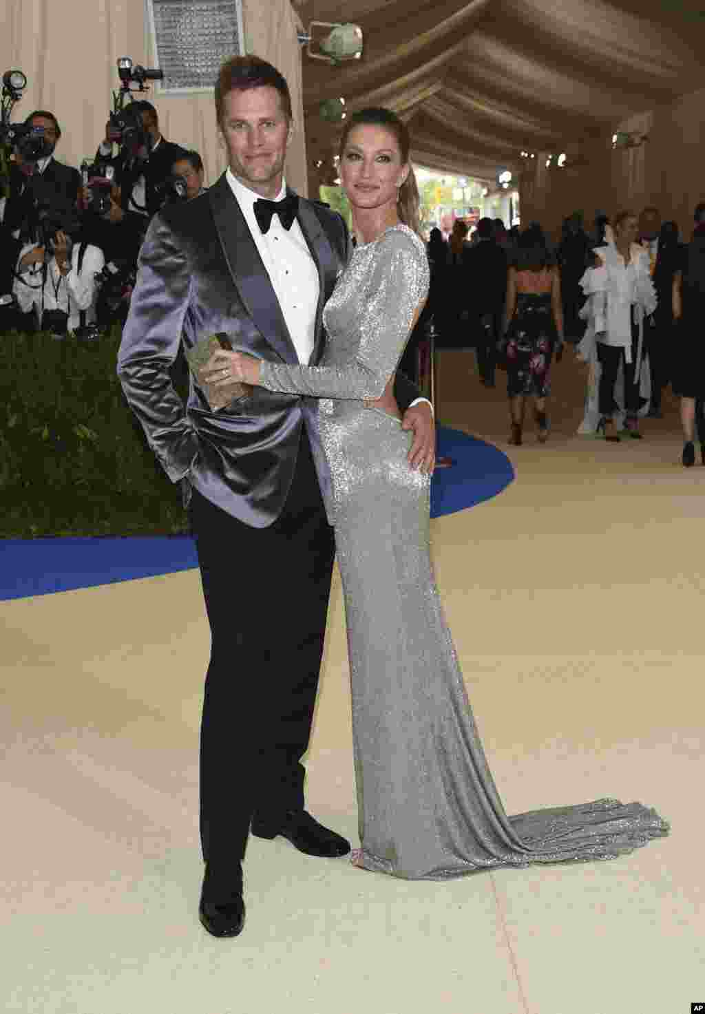 曾四次获得“超级碗”MVP称号的橄榄球四分卫汤姆·布拉迪(Tom Brady)(左一)和巴西超模吉赛尔·邦辰(Gisele Bundchen) (右一)参加在纽约大都会博物馆举办的时装馆慈善晚会,庆祝"中间的艺术"展览开幕。(2017年5月1日)
