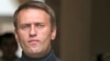 Russian opposition leader Alexei Navalny speaks to the media gathered outside his headquarters in Moscow, Sept. 9, 2013. 