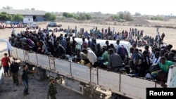 Migrants rides in a truck before they are transported to a detention center, in the coastal city of Sabratha, Libya, Oct. 7, 2017. 