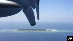 FILE - In this March 23, 2016, file photo, an aerial view is seen from a military plane of the Taiwan-controlled Taiping island, also known as Itu Aba.