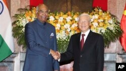 Indian President Ram Nath Kovind, left, shakes hands with Vietnamese President Nguyen Phu Trong before heading for talks behind closed doors in Hanoi, Vietnam, Tuesday, Nov. 20, 2018.