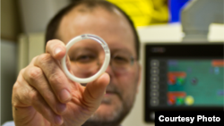Caption: Northwestern University biomedical engineer Patrick Kiser holds an intravaginal ring - the first of its kind - that reliably delivers an antiretroviral drug and a contraceptive for months. (Northwestern University)