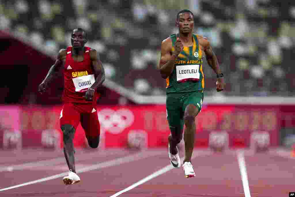 Gift Leotlela, of South Africa, right, wins a heat in the men's 100-meter run at the 2020 Summer Olympics, Saturday, July 31, 2021, in Tokyo. (AP Photo/Petr David Josek)