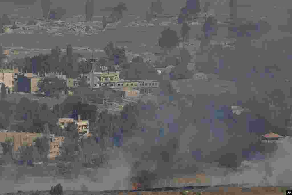 Smoke and fire rise in the Quneitra province as Syrian rebels clash with President Bashar al-Assad’s forces, as seen from the Israeli controlled-Golan Heights, Aug. 27, 2014. 