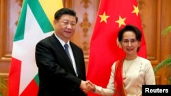 中国国家主席习近平和缅甸国务资政昂山素季1月18日举行会晤。