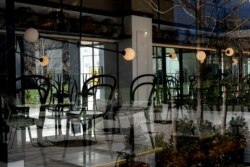 FILE - An empty restaurant is seen in Manhattan borough following the outbreak of coronavirus disease (COVID-19), in New York City, March 15, 2020.