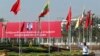 A traffic police stands on a road as he clears a road near a welcoming billboard to Chinese President Xi Jinping Friday, Jan. 17, 2020, in Naypyitaw, Myanmar.
