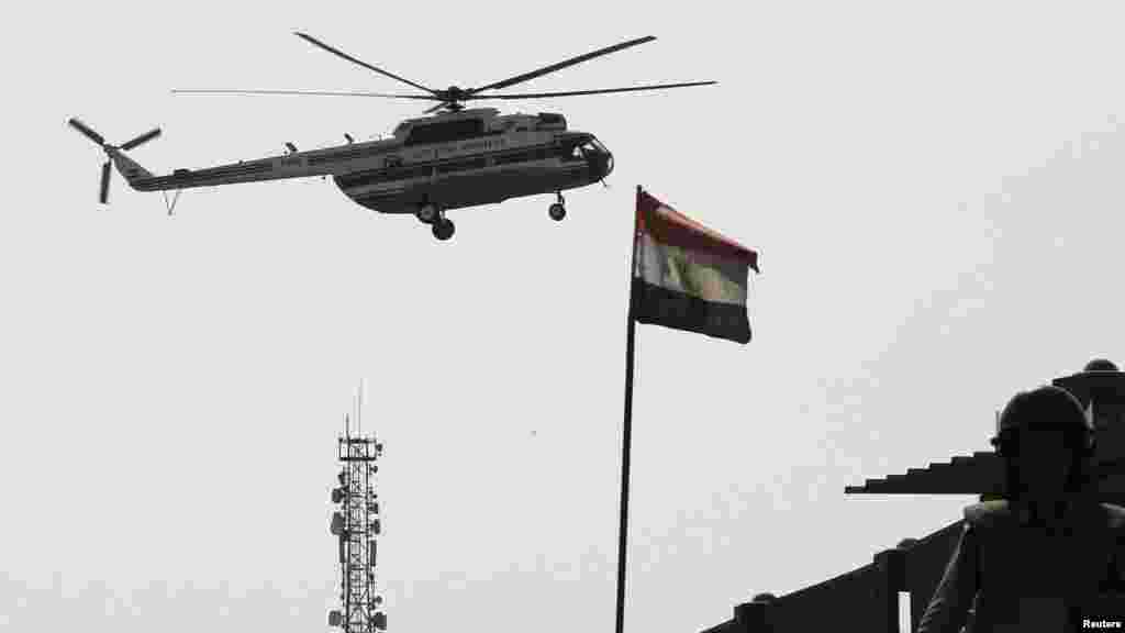 A soldier stands guard as a helicopter ambulance carrying former Egyptian President Hosni Mubarak flies towards Maadi Military Hospital at the southern suburb of Maadi on the outskirts of Cairo, August 22, 2013. Mubarak was flown from jail on Thursday in