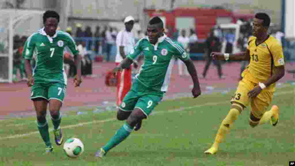 Nigeria's Musa Ahmed, left, Emenike Emmanuel, centre, vie for the ball against Ethiopia's Salahadin Bargicho, right, during their 2014 World Cup qualifying playoff match.