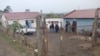 Police officials work at the scene of a mass shooting in Lusikisiki