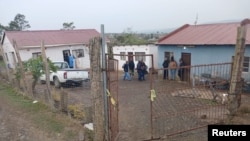 Police officials work at the scene of a mass shooting in Lusikisiki