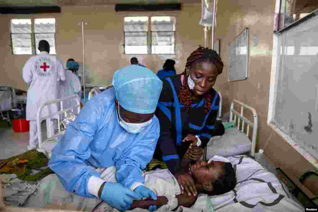 A health worker attends to a newly-admitted patient with a suspected bullet wound at the CBCA Ndosho hospital in the town of Sake, near Goma in eastern Democratic Republic of Congo, following the intense fighting between M23 rebels and the Armed Forces of the Democratic Republic of the Congo.