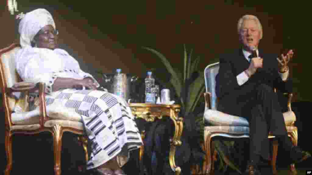 Nigerian Minister of Finance, Ngozi Okonjo-Iweala listens to U.S. Former President Bill Clinton as he answers questions at an annual ThisDay awards ceremony, Feb. 13, 2012.