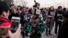 FILE - A journalist operate a harness with multiple recording devices capable of recording and live streaming outside the Great Hall of the People in Beijing, China. 
