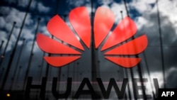 (FILES) In this file photo taken on November 6, 2019 the logo of Chinese telecom giant Huawei is pictured during the Web Summit in Lisbon. - The United States on November 18, 2019 granted another 90 days for companies to cease doing business with American companies.