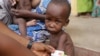 FILE - A doctor attends to a malnourished child at a refugee camp in Yola, Nigeria. Doctors Without Borders says nearly 200 refugees from Boko Haram have died of starvation and dehydration in the city of Bama in the past month. 