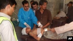 A Pakistani child who was injured in a suicide bombing is treated at a local hospital in Khar, Pakistan, Friday, Sept. 16, 2016. A suicide bomber attacked a Sunni mosque in northwest Pakistan on Friday, killing dozens of worshippers.