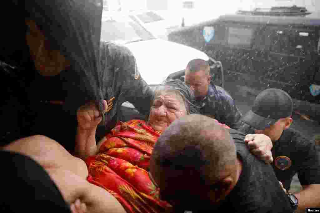 Rescue workers carry a woman into the Emergency Operation Centre after the the area was hit by Hurricane Maria in Guayama, Puerto Rico, Sept. 20, 2017.