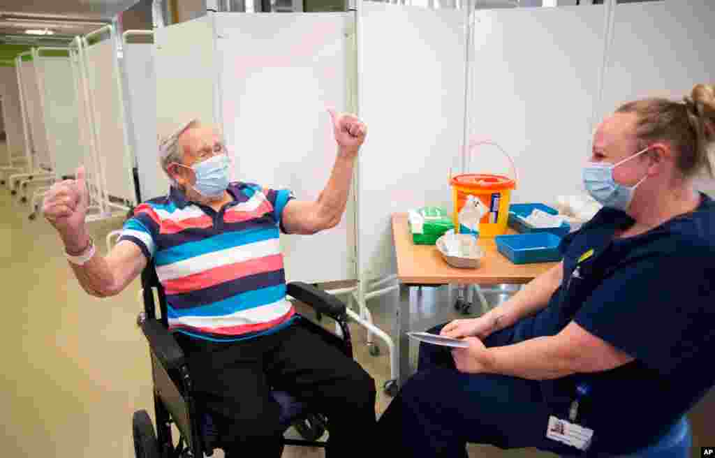 Henry (Jack) Vokes, 98, reacts receiving the Pfizer-BioNTech COVID-19 vaccine at Southmead Hospital, Bristol, England, Dec. 8, 2020.