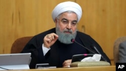 FILE - photo, released by official website of the office of the Iranian Presidency, President Hassan Rouhani speaks in a cabinet meeting in Tehran, Iran.
