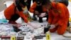 Rescue workers lay out recovered belongings believed to be from the crashed Lion Air flight JT610 at Tanjung Priok port in Jakarta, Indonesia, October 30, 2018. 