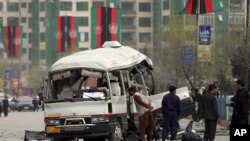 FILE - Security personnel inspect the site of a bomb attack in Kabul, Afghanistan, March 15, 2021.