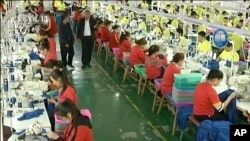 FILE - In this file image from undated video footage run by China's CCTV via AP Video, Muslim trainees work in a garment factory at the Hotan Vocational Education and Training Center in Hotan, Xinjiang, northwest China.