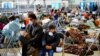 FILE - Evacuees from Afghanistan wait with other evacuees to fly to the United States or another safe location in a makeshift departure gate inside a hangar at the U.S. airbase in Ramstein, Germany, Sept. 1, 2021. 