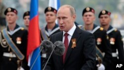 Rossiya rahbari Vladimir Putin Qrimdagi harbiy paradda so'zlamoqda. 2014-yilning 9-mayi. Sharqiy Yevropa davlatlari Rossiyani o’z xavfsizligiga tahdid deb ko’rishi tufayli NATO kengayishi yana ko’tarilmoqda.