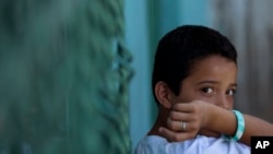 Edwin Lemus, 10, from El Salvador, sits in the men's section of a shelter providing temporary refuge to Central American migrants on their way north, in Arriaga, Chiapas State, Mexico, June 18, 2014.