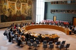FILE - Members of the U.N. Security Council gather inside the United Nations Security Council chambers in New York, for a meeting on Syria, April 30, 2019.